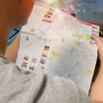 Traveler studying a map for directions, symbolizing exploration and adventure.
