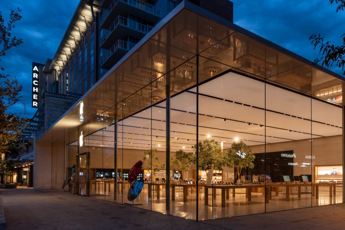 Stunning view of a modern glass building exterior illuminated at night.