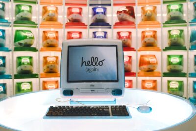Retro Apple iMac G3 display showcasing technology evolution with colorful computer units.